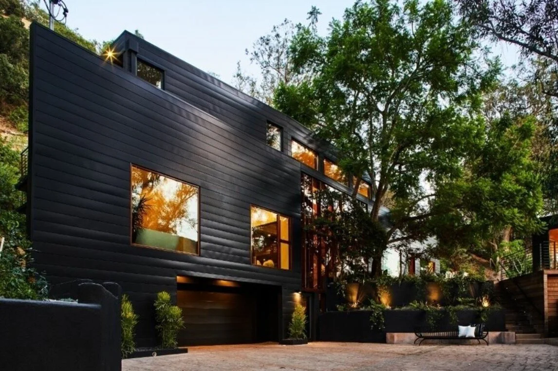 Modern black-clad custom home by JBC Design & Build on a wooded California hillside