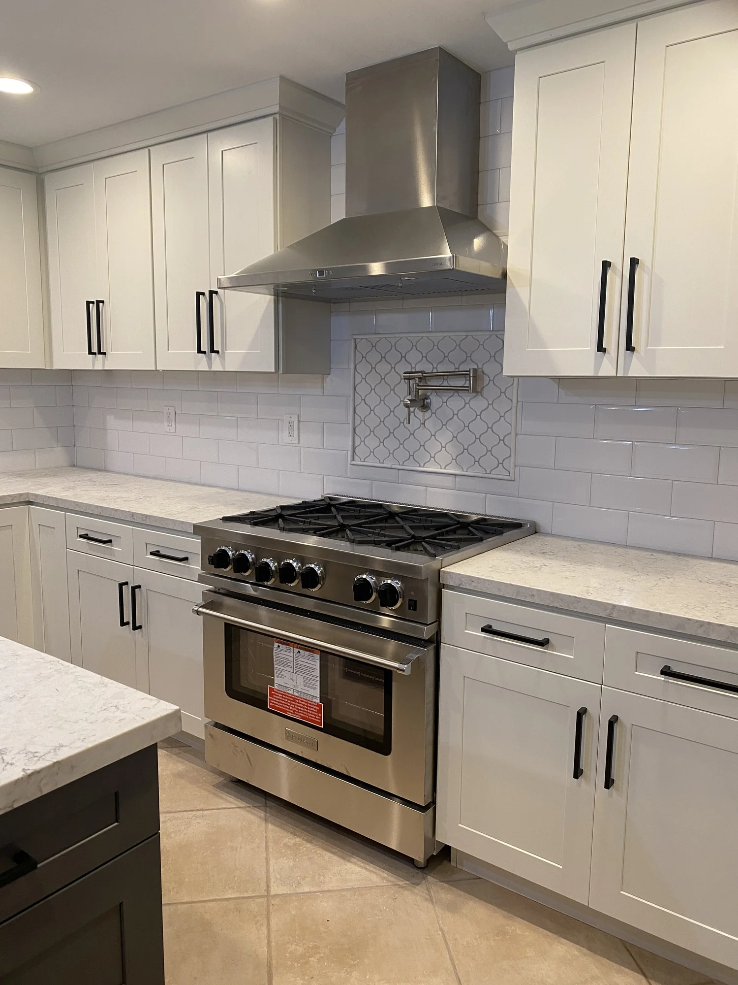Custom kitchen remodel with stainless range and quartz counters by JBC