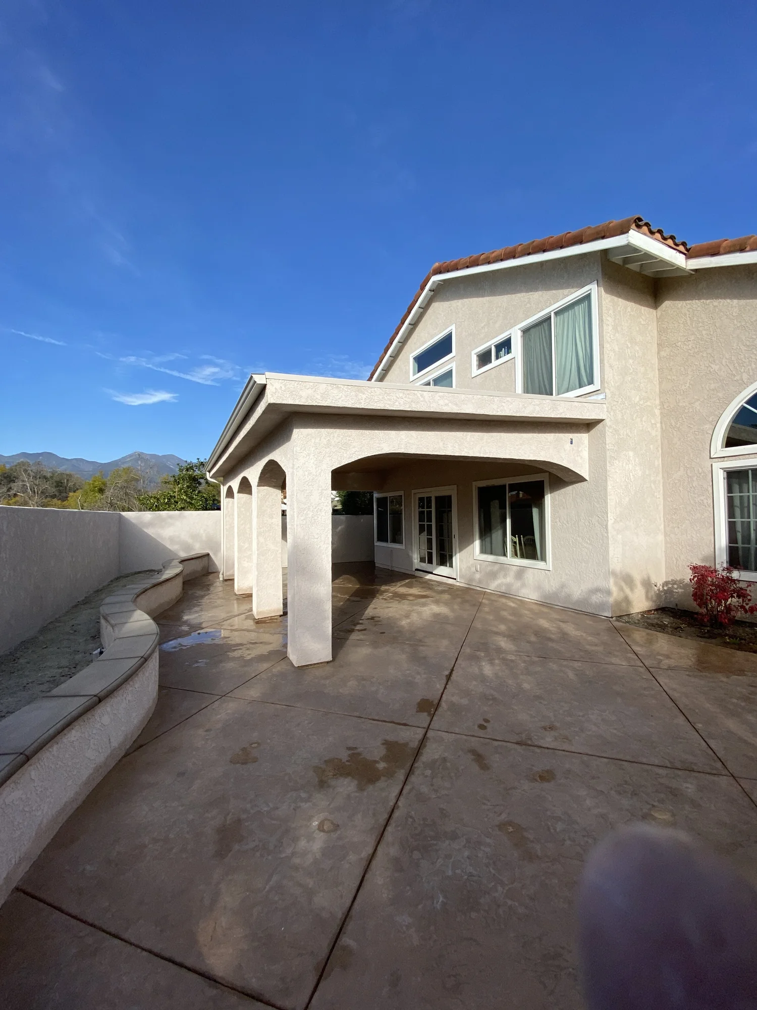 Two-story home exterior with new covered patio addition by JBC