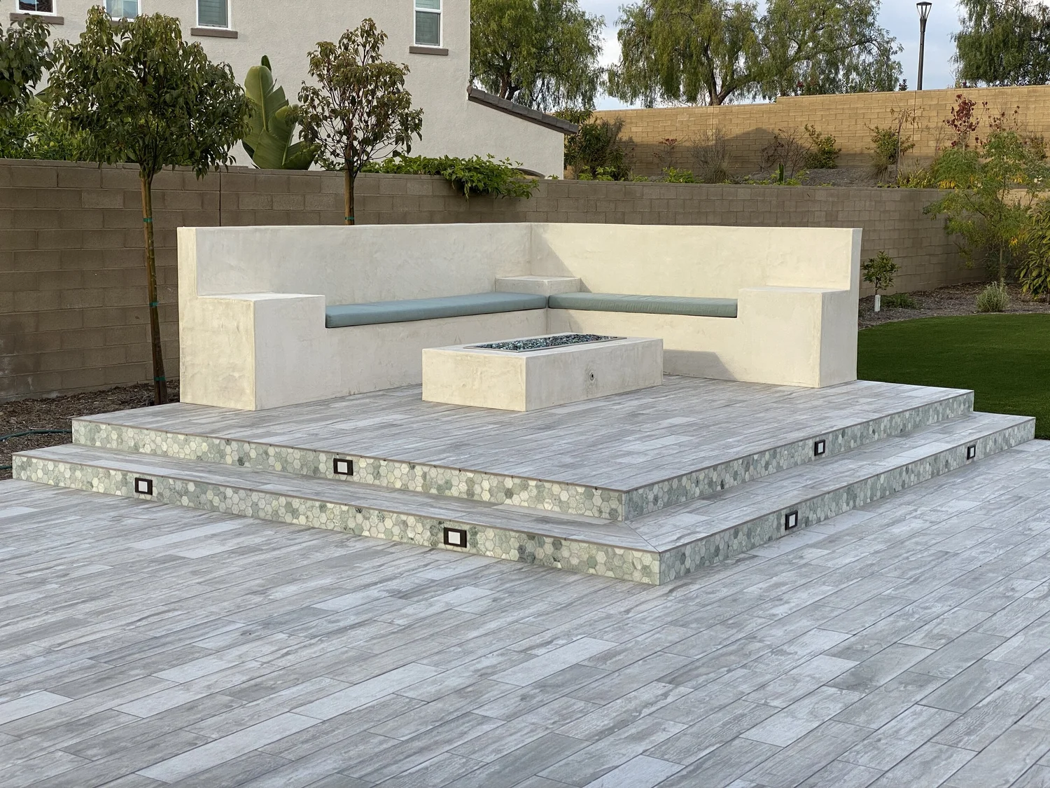 Resort-style backyard with paver patio and built-in spa by JBC